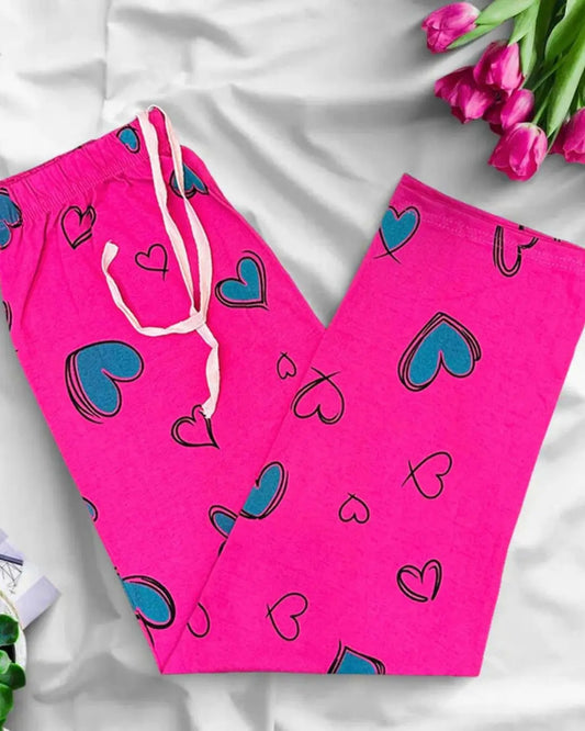 Pink lounge trousers with a green heart print and a white drawstring.