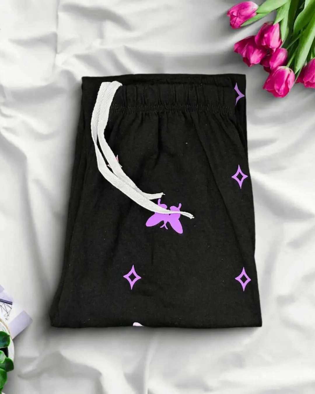 Black trousers with a purple butterfly print.