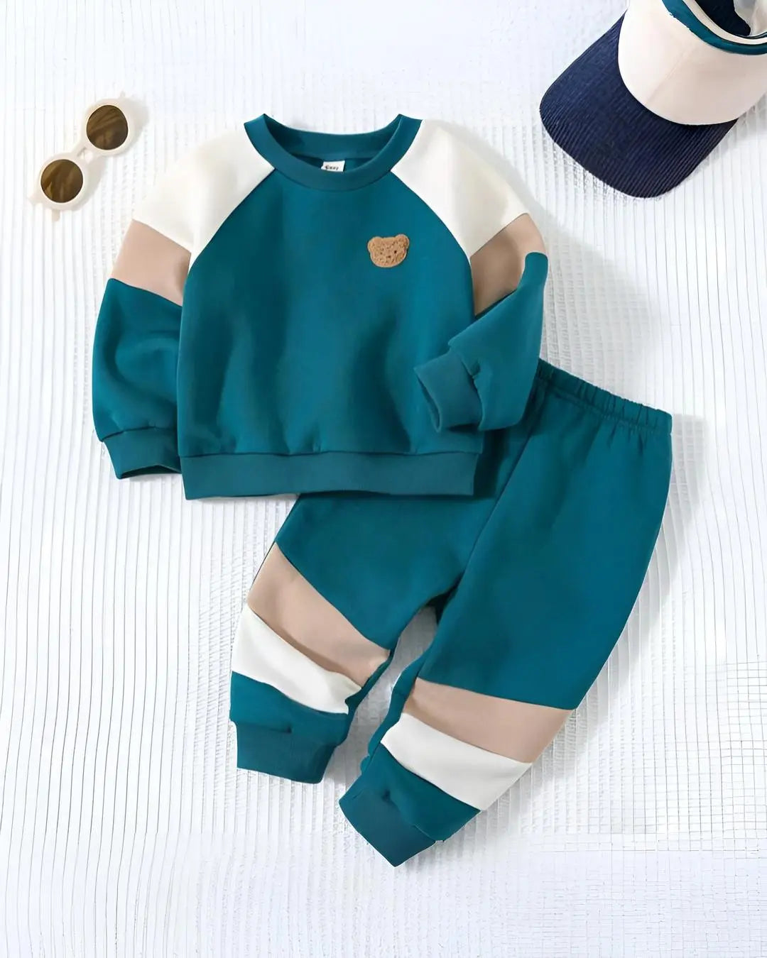 A kids' two-piece winter suit in a vibrant green color with a cute teddy 