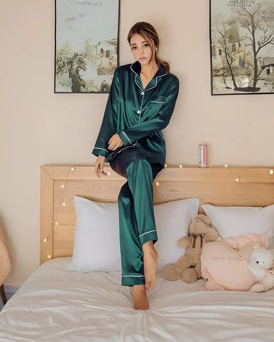 A full view of a green silk pajama set, including a long-sleeve top and matching pants.