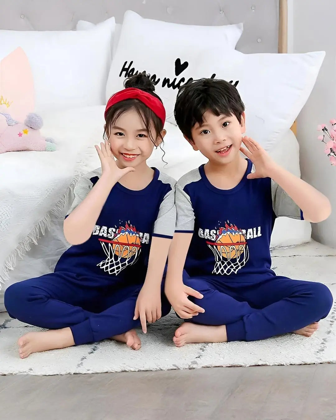 A young child wearing a half-sleeved blue and white basketball suit, standing in a playful pose.