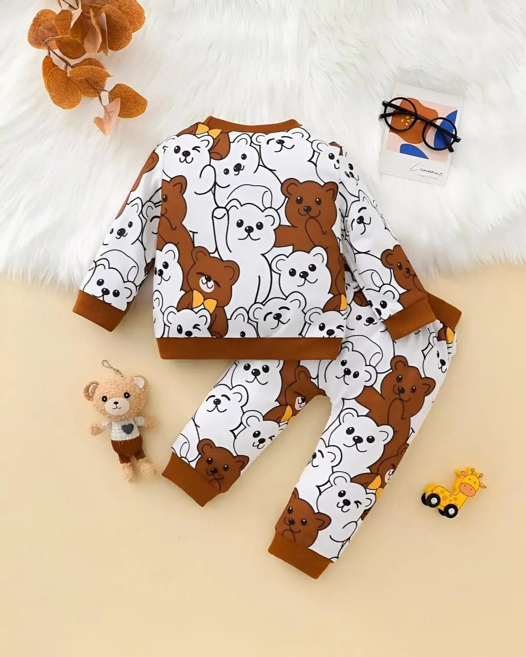 A kids' two-piece winter suit with a repeating print of brown and white bears.