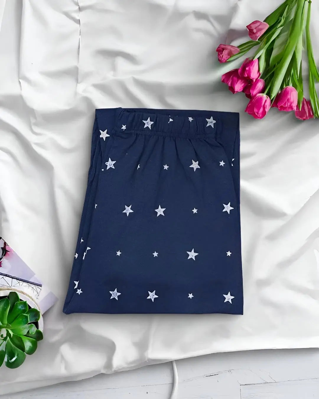 Navy blue star print trousers, a comfortable and stylish pajama or lounge pants.