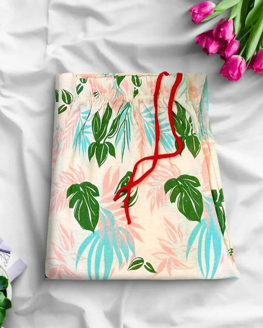 Peach tropical leaf print lounge trousers with a red drawstring.