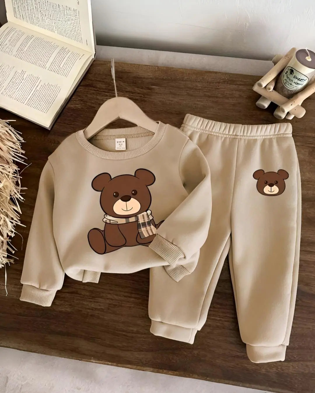 A kids' two-piece winter suit with a cute, repeating teddy bear print.