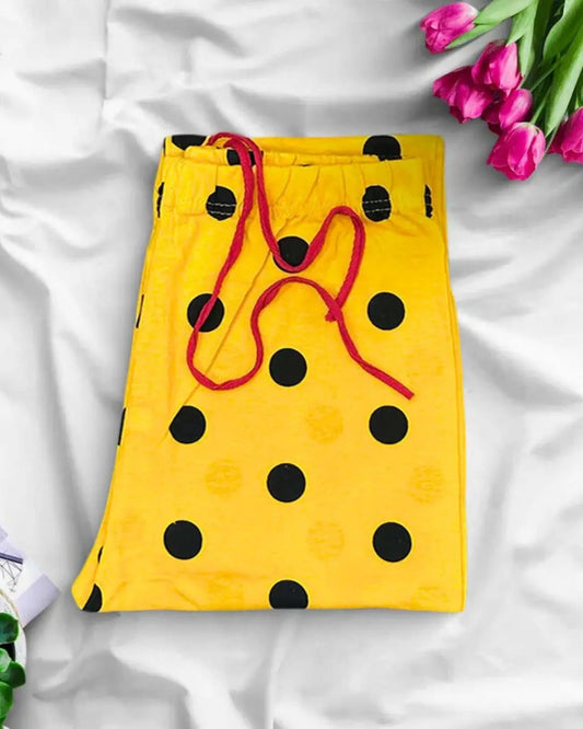 Yellow polka dot lounge trousers with a black print and red drawstring.